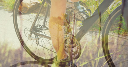 Image of grass over caucasian woman cycling. national bike to work day and celebration concept digitally generated image.の写真素材