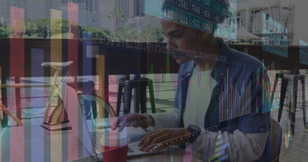 Image of statistics and data processing over man using laptop. Global networks, business, finance, computing and data processing concept digitally generated image.の写真素材