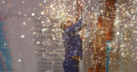Image of glowing spots of light over caucasian man carrying box working in warehouse,. global...