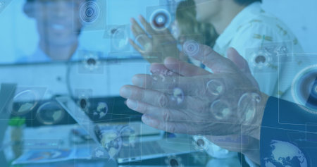 Image of diverse data on digital screen over businesspeople clapping hands. Business, cooperation, communication and technology concept digitally generated image.の写真素材