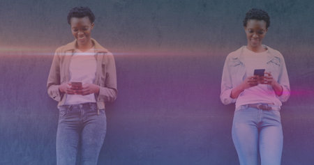 Image of smiling african american women using smartphones. national siblings day and celebration...