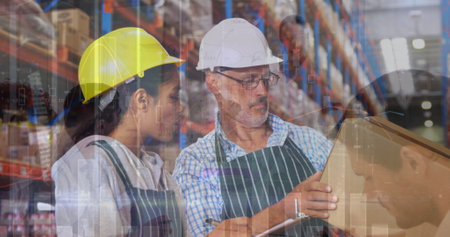 Image of financial data over diverse female and male warehouse workers. Business, trade, delivery and finance concept digitally generated image.の写真素材