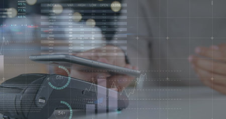 Image of financial data and graphs over hands of caucasian man using smartphone. Finance, economy,...