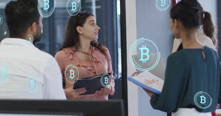 Image of bitcoin symbols over diverse colleagues having meeting in office. Business, communication,...