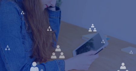 Image of network of connections with icons over caucasian woman using tablet. Global communication,...