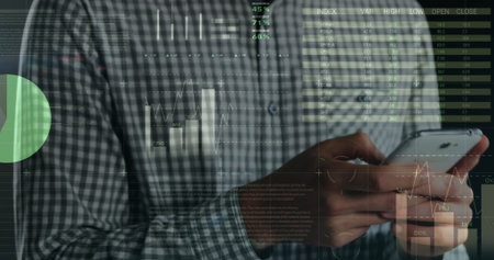 Image of financial data and graphs over hands of caucasian man using smartphone. Finance, economy,...
