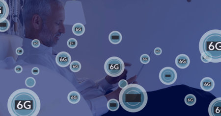 Image of network of connections with icons over caucasian man using smartphone. Global...