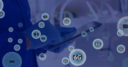 Image of network of connections with icons over caucasian male doctor using tablet. Global communication, business, connections, computing and data processing concept digitally generated image.の写真素材