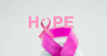 Image of breast cancer awareness text over pink breast cancer ribbon. breast cancer positive awareness campaign concept digitally generated image.の写真素材