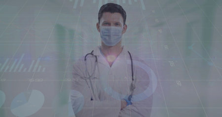 Image of data processing over caucasian male doctor with face mask. global medicine and data processing during covid 19 pandemic concept digitally generated image.の写真素材