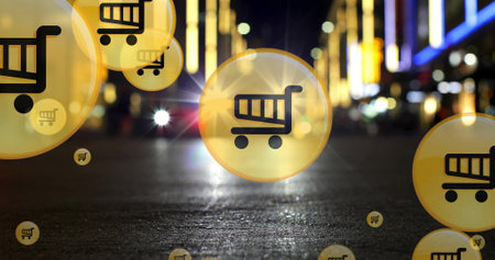 Image of shopping cart icons over low angle view of car moving on street in city. Digital composite, multiple exposure, defocused, buying, retail, shopping and transportation concept.の写真素材