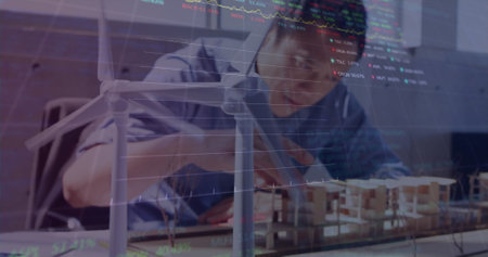 Image of stock market data processing over asian male engineer working on his model at office....