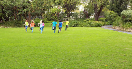 Image of back to school text over schoolchildren playing outdoors. education, development and learning concept digitally generated image.の写真素材