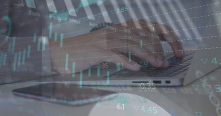 Image of financial data processing over man using laptop. Global computing, business, finance and data processing concept digitally generated image.の写真素材