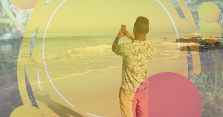 Image of frame over back view of african american man taking photo on beach. Relax, vacations and holidays concept digitally generated image.の写真素材