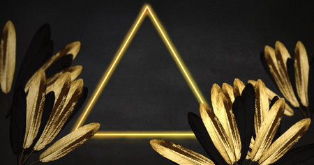 Image of copy space and neon triangle over leaves on gray background. Retro future and digital interface concept digitally generated image.の写真素材