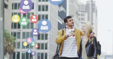 Image of social media icons floating over happy caucasian couple walking and smiling. social media...