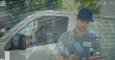 Statistical data processing against portrait of caucasian delivery man with clipboard smiling. logistics and transportation business conceptの写真素材