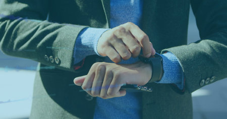 Image of data processing over biracial businessman using smartwatch. Global business and digital interface concept digitally generated image.の写真素材