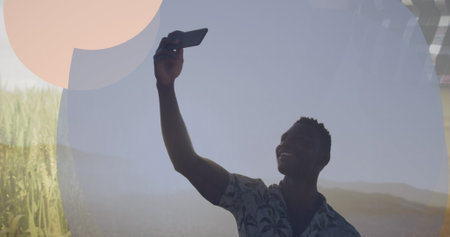 Image of frame over happy african american man taking selfie. Relax, vacations and holidays concept...