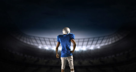 Rear view of an American football athlete limbering up preparing to enter a digital stadium 4kの写真素材