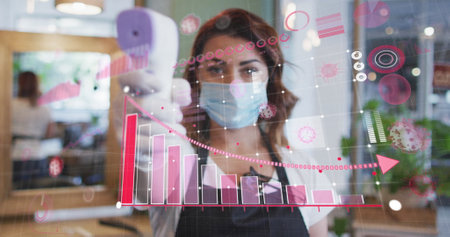 Image of diagrams over caucasian female hairdresser taking temperature and wearing face mask....