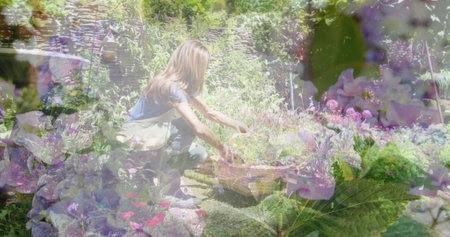 Composite image of flowers in the garden against caucasian woman keeping plant pots in a basket. community garden week awareness conceptの写真素材