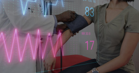 Image of colourful cardiographs over diverse patient and doctor taking pressure. Medicine, health...