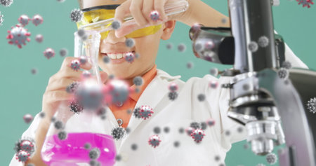 Image of coronavirus cells flowing over a view of male student using chemistry equipment. Covid 19...