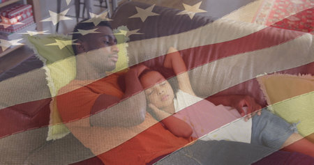 Image of flag of usa waving over african american father lying on sofa with sleeping daughter. american patriotism, independence and celebration concept digitally generated image.の写真素材