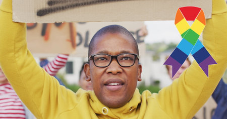 Image of rainbow ribbon over african american male protester with banner. lgbt rights and equality...
