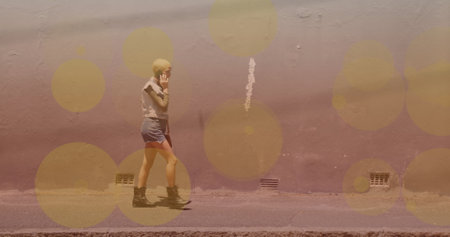 Image of light spots over caucasian woman walking. walk day and celebration concept digitally generated image.の写真素材