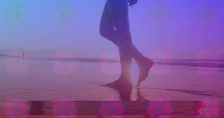 Pink square design pattern against low section of a woman walking on the beach. Love and relationship conceptの写真素材