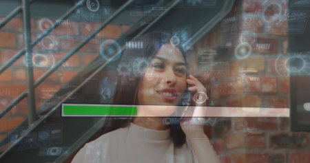 Image of data on digital screen over happy biracial woman having call in office. Business, network and technology concept digitally generated image.の写真素材