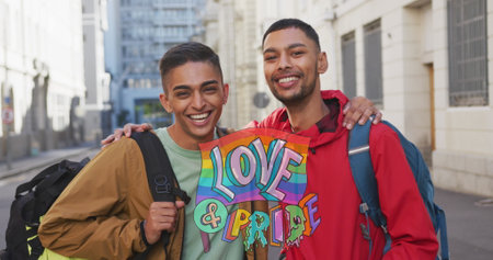 Image of love and pride over gay couple embracing on street. lgbt rights and equality concept...