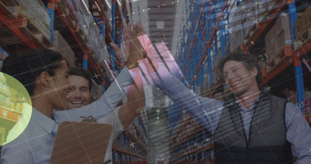 Statistical data processing against male and female supervisors high fiving each other at warehouse. logistics and transportation business conceptの写真素材