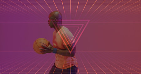 Image of neon pattern over african american basketball player. Sports, competition, data processing and communication concept digitally generated image.の写真素材