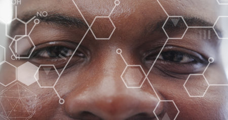 Image of elements over african american male doctor smiling. Global healthcare, science, medicine, research, computing and data processing concept digitally generated image.の写真素材