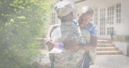 Image of flag of usa waving over african american soldier and his son. american patriotism, independence and celebration concept digitally generated image.の写真素材