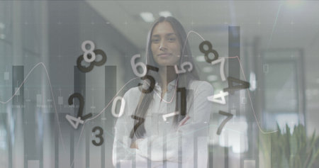 Image of financial data processing with numbers over biracial businesswoman working at office. Global business, finances and digital interface concept digitally generated image.の写真素材