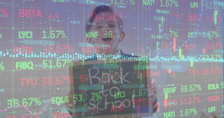 A schoolboy holding a chalkboard with the text back to school.   meant to represent statistics...