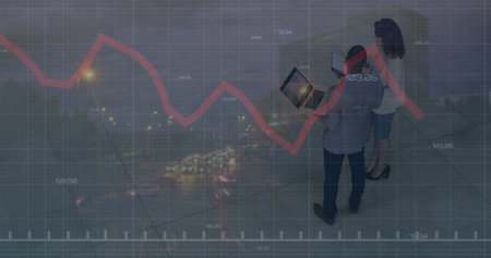 Image of financial data and graphs over diverse coworkers in office. Business, finance, economy and cooperation concept digitally generated image.の写真素材