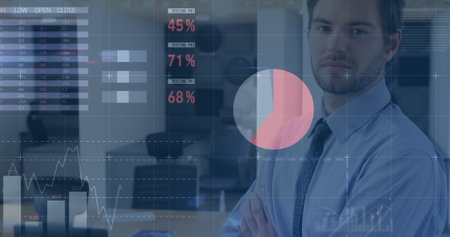 Caucasian male in office attire analyzing data on glass screen. He has stubble, brown hair, and is...