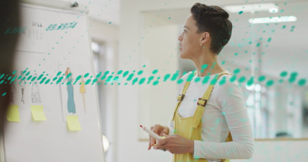 Image of data processing over biracial businesswoman in office. Global business and digital...