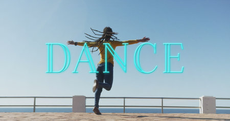 Neon dance text banner against african american woman dancing on the promenade. dance and hobby conceptの写真素材