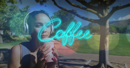 Neon blue coffee text banner against african american woman drinking coffee in the park. cafe and business conceptの写真素材