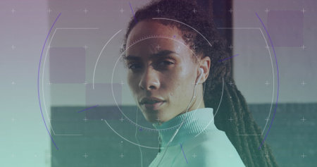 Scope scanning against portrait of african american fit woman wearing earphones. sports, fitness and technology conceptの写真素材