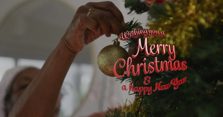 Image of wishing you a merry christmas and a happy new year text over african american woman. Christmas, tradition and celebration concept digitally generated image.の写真素材