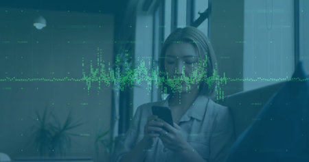 Image of financial data processing over caucasian businesswoman using smartphone. Global finance, business, connections, computing and data processing concept digitally generated image.の写真素材