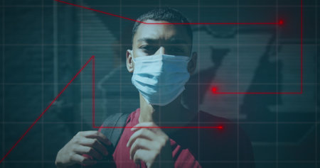 Image of graph over biracial man wearing face mask. Health and lifestyle during covid 19 pandemic concept digitally generated image.の写真素材